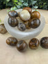 Assorted polished mystery tumble stones in varied colors and patterns